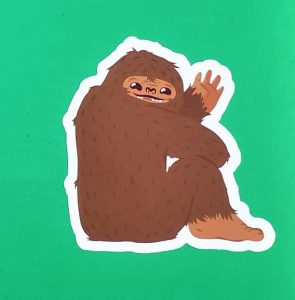 Cartoon Shaggy Brown Bigfoot Sitting Sticker